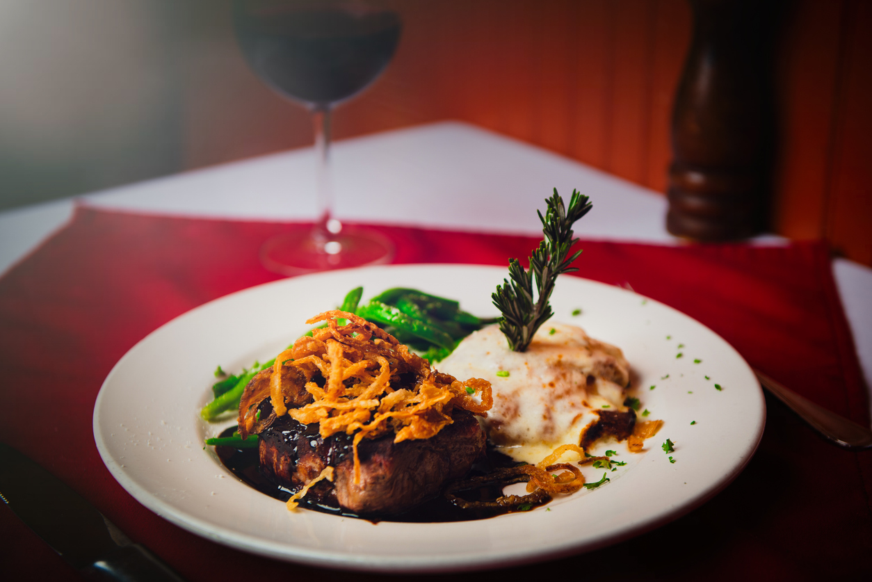 Pan seared filet mignon with wine sauce Pan seared filet mignon with wine sauce and a glass of red wine